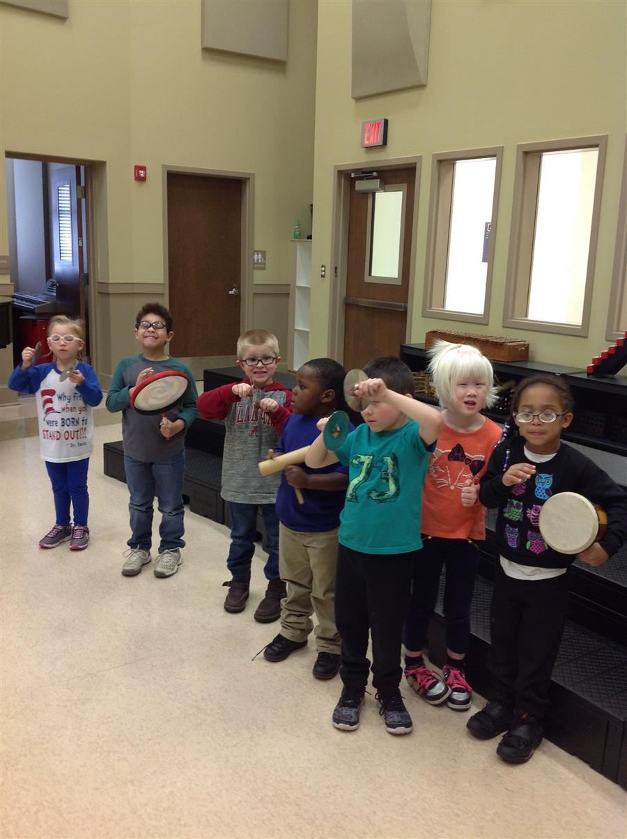 A group of students with handheld percussion instruments. 