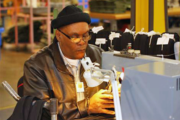  David Marshall sits at his sewing machine on the AIB production floor as he manufacturers a nectie.