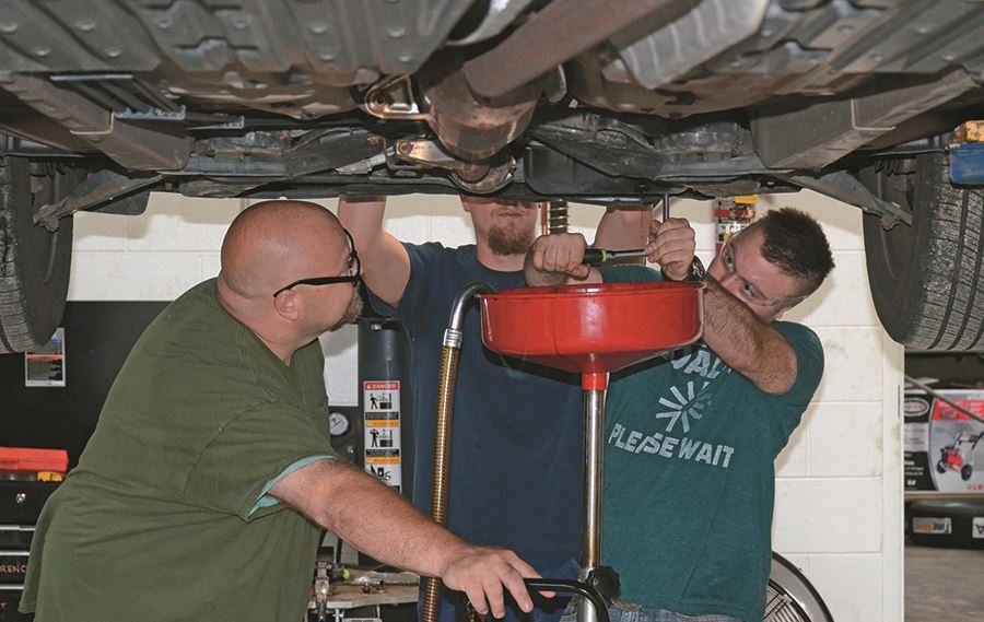 EHG clients receive instruction on how to change a car's oil EHG clients receive instruction on how to change a car's oil