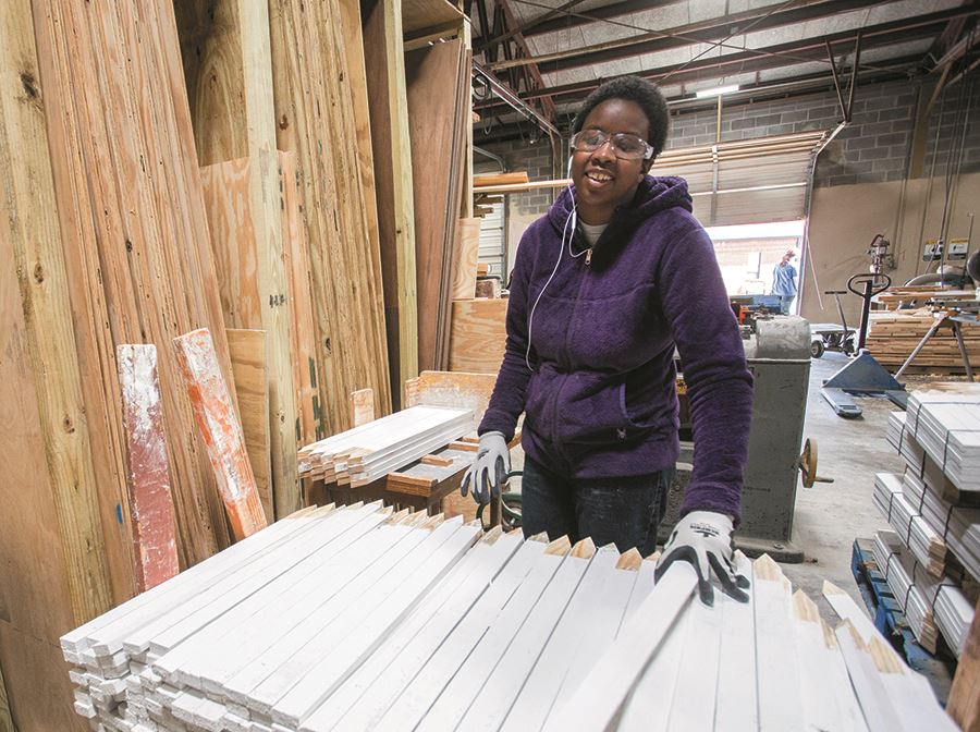 A client paints stakes white as part of her training at EHG A client paints stakes white as part of her training at EHG