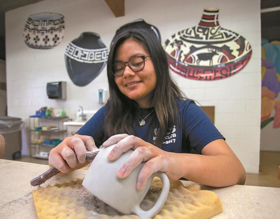 An EHG client does ceramics as part of the extended daycare and recreation program An EHG client does ceramics as part of the extended daycare and recreation program