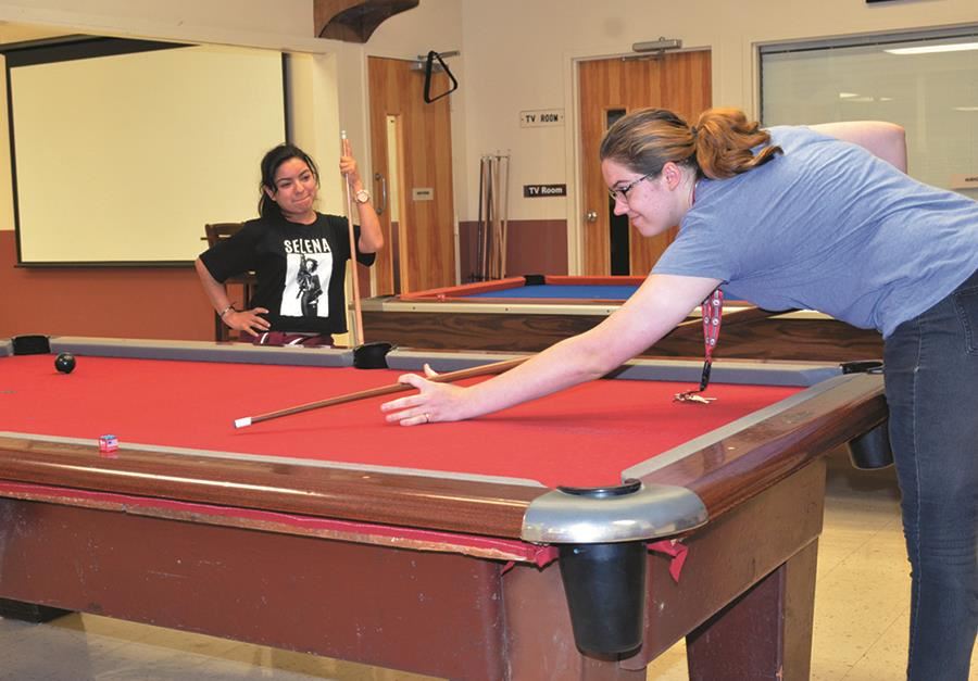 Two EHG clients shoot pool as part of the extended daycare and recreation program Two EHG clients shoot pool as part of the extended daycare and recreation program