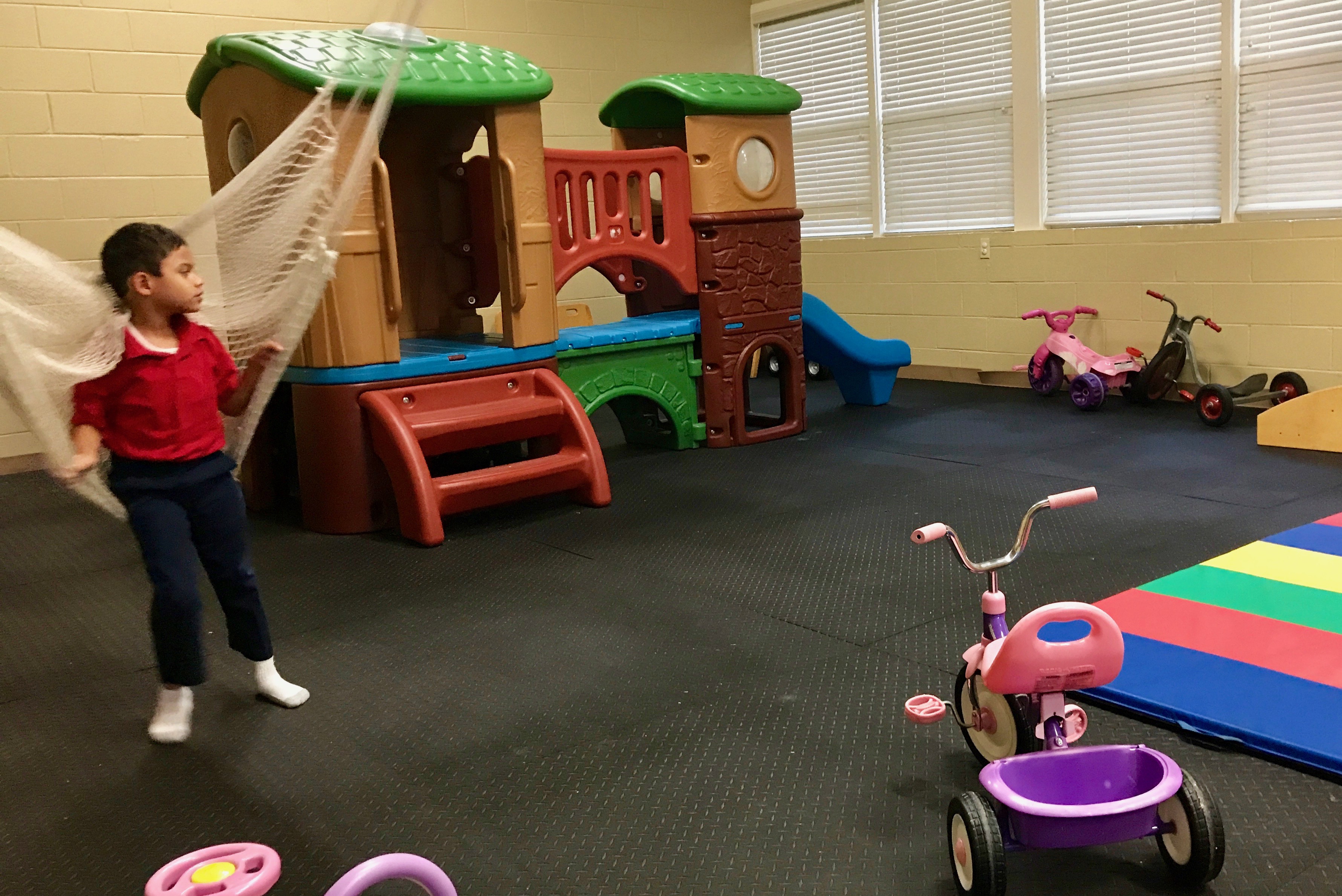 boy on swing at indoor play area 
