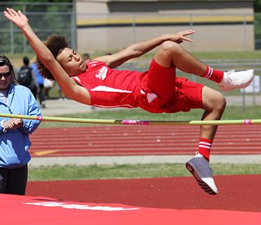An ASB athlete clears the bar in the high jump 