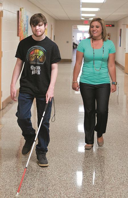 An EHG client receives instruction on how to use a white cane 