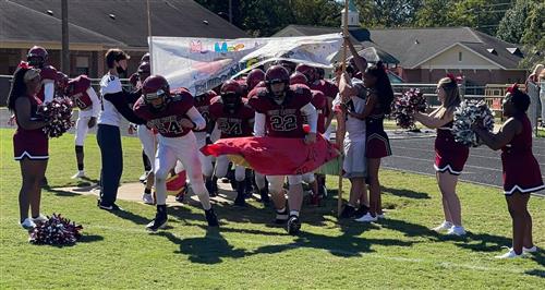Alabama School for the Deaf Football team running through a banner onto the football field
