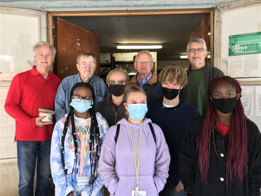 ASB Students pose with Samaritan House volunteers for a group picture. 