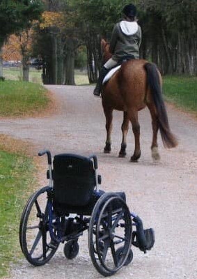 MGH Student riding horse leaving wheel chair behind