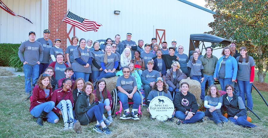 A photo of MGHSE staff and volunteers gathered outside the MGH arena. 