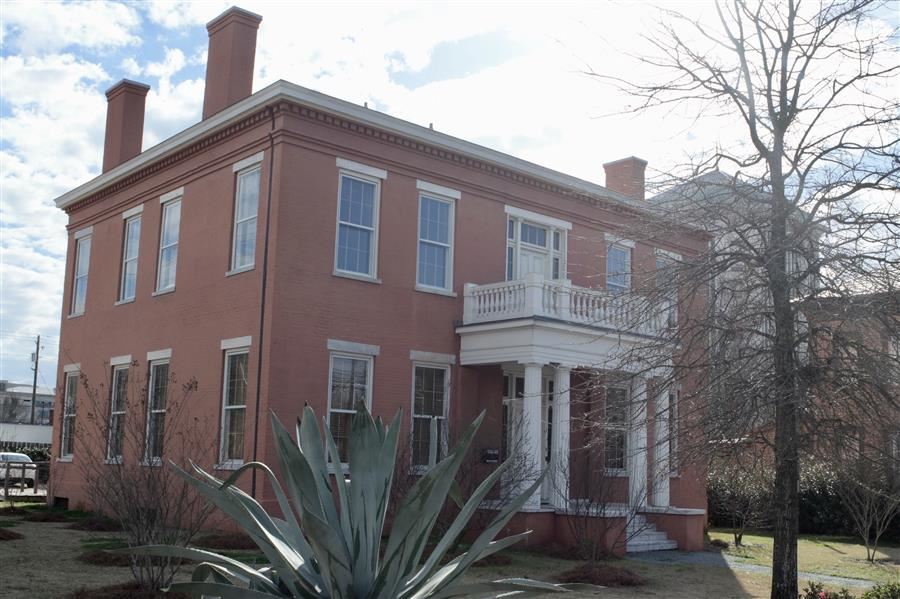 image from the road of the entire Montgomery Regional center, an old red stucko house
