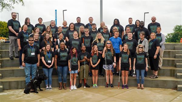 Portait of thirty plus GenCyber students and faculty lined up in 4 rows on a set of stairs.