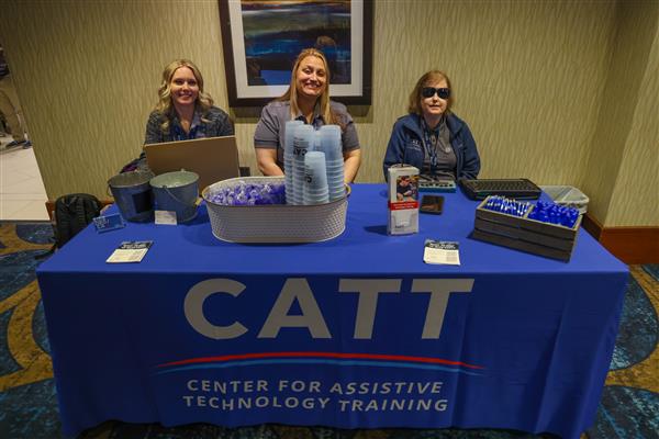 CATT staff Megan Green, Katy Reid, and Jill Dunaway pose for a picture at CATT's DBL booth