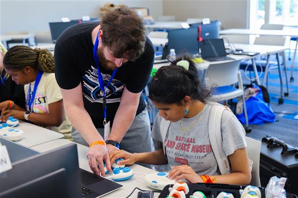 trainer Jason Martin showcasing CodeJumper to student at GenCyber 2023 camp