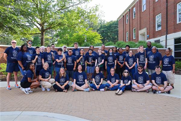 group photo of GenCyber students and staff all wearing navy blue t-shirts