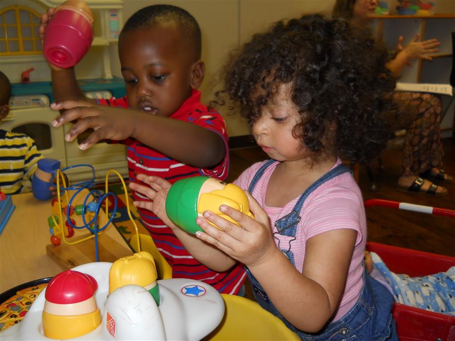 Two toddlers playing with a sensory table.