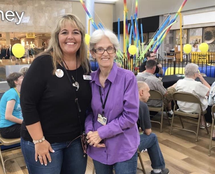 Interpreter Coordinator and member of Deaf Community at community event.